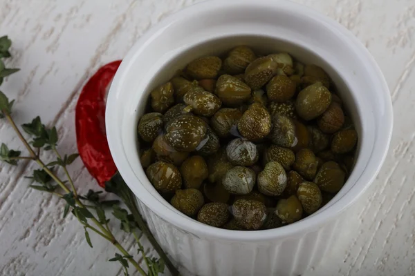 Pickled capers in the bowl — Stock Photo, Image