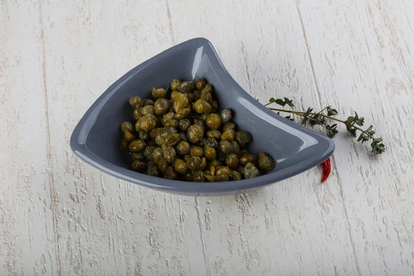 Pickled capers in the bowl — Stock Photo, Image