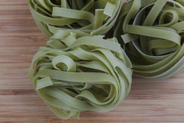 Raw tagliatelle pasta — Stock Photo, Image