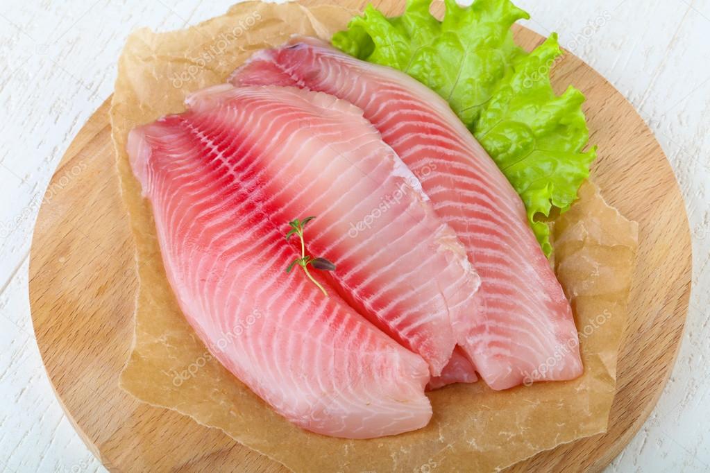 Raw Tilapia fillet Stock Photo by ©AndreySt 109001728