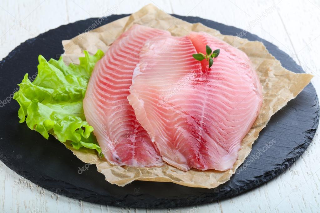 Raw tilapia fish fillet Stock Photo by ©AndreySt 111568270