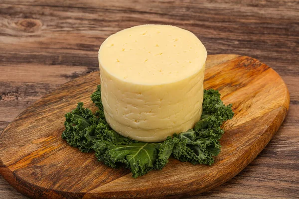 Yellow round dairy soft cheese piece
