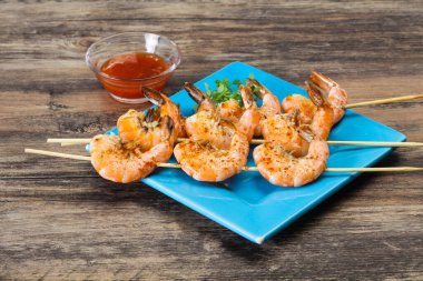 Baharatlı soslu ızgara karides şişi.