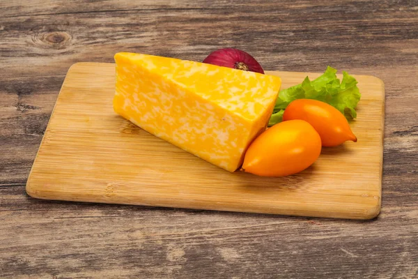 Marble cheese  triangle over wooden background