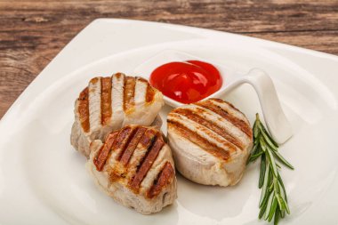 Domates soslu ızgara domuz madalyonu. Biberiye servis ediliyor.