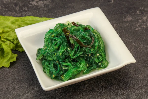 Green Chuka Seaweed Salad Isolated on White Background Top View. Wakame Sea Kelp Salat, Chukka Sea Weed, Healthy Algae Food