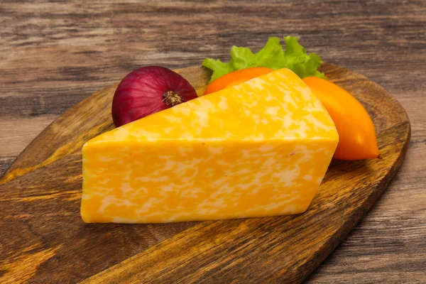 Marble cheese  triangle over wooden background