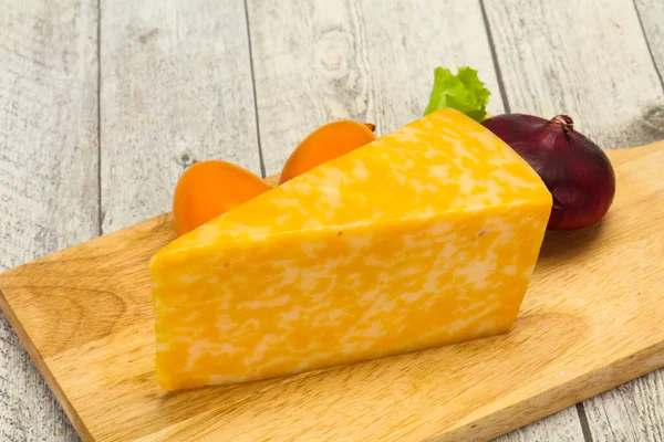 Marble cheese  triangle over wooden background