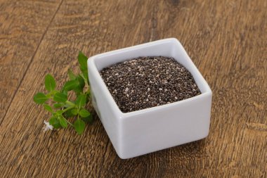 Tahta arka planda diyet Chia tohumları var.