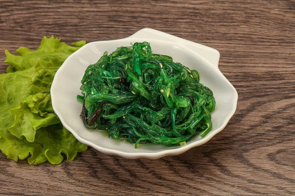 Green Chuka Seaweed Salad Isolated on White Background Top View. Wakame Sea Kelp Salat, Chukka Sea Weed, Healthy Algae Food