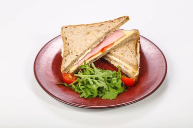 Jambonlu ve peynirli sandviç roka servis edildi.