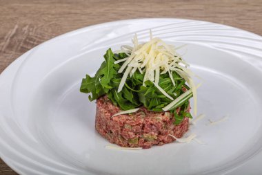 Çiğ etli tartar, roka, peynir ve parmesan peyniri.