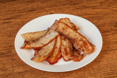 Kızarmış domuz pastırması tabakta.