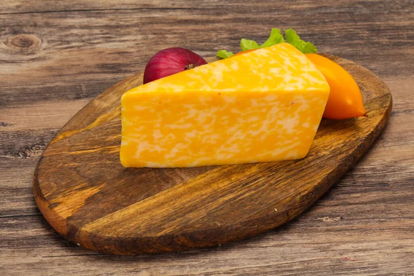 Marble cheese  triangle over wooden background