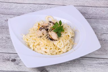 İtalyan makarnası, midye ve peynirli fesleğen.