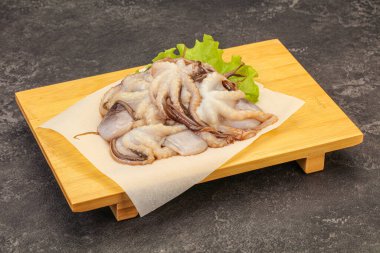 Çiğ deniz ürünleri - ahtapot tahtada pişirmek için.