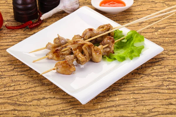 Chicken skin skewer with chili sauce