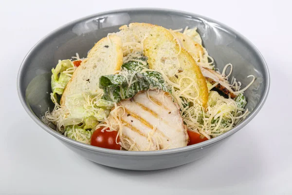 Traditional Caesar salad with chicken and cherry tomato