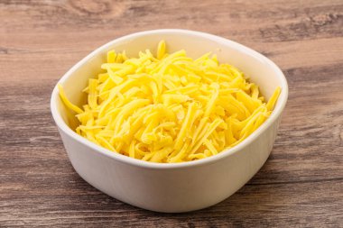 Yemek pişirmek için kasede dilimlenmiş sarı peynir.