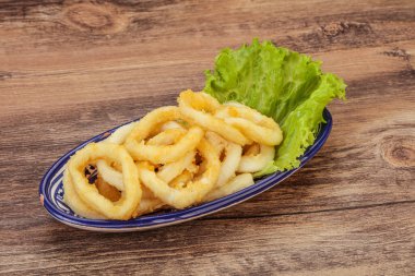Kavrulmuş kalamar halkaları ve kasede salata.