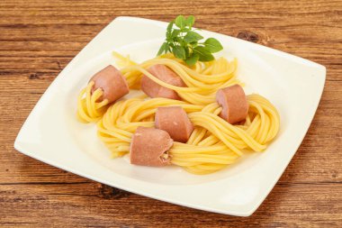 Çocuklar sosisli ve fesleğenli makarna.