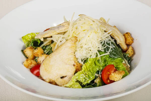 Traditional Caesar salad with chicken and cherry tomato