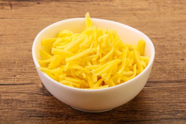 Yemek pişirmek için kasede dilimlenmiş sarı peynir.