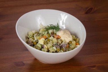 Etli ve bezelyeli geleneksel Rus salatası.