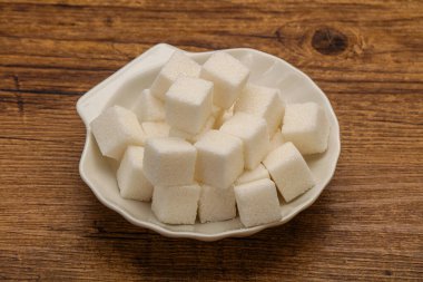 Rafine edilmiş beyaz granüllü şeker yavruları kasede.