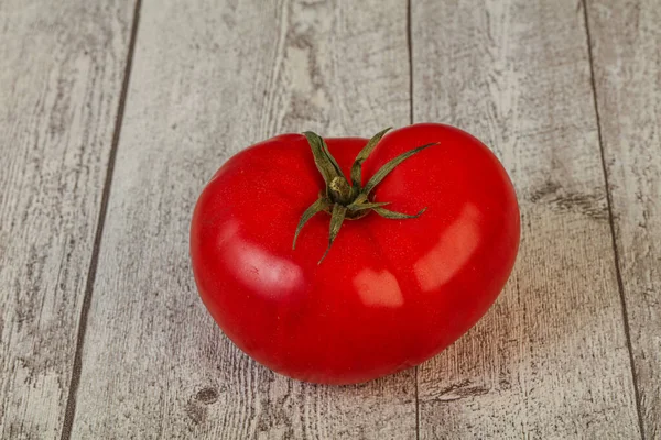 Ripe tasty red big tomato over background