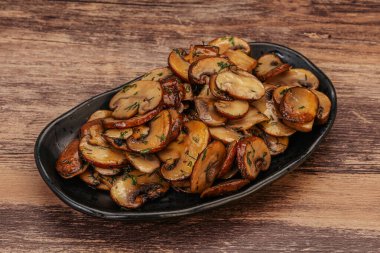 Kavrulmuş şampiyon, kasede otlar ve baharatlar var.