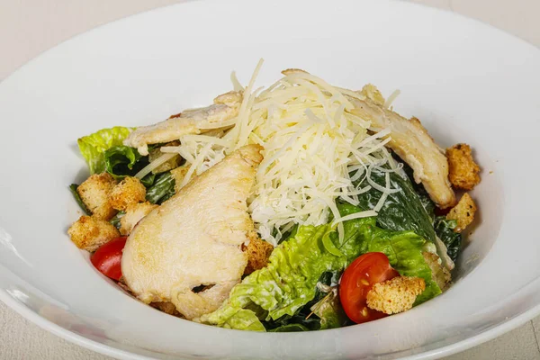 Traditional Caesar salad with chicken and cherry tomato