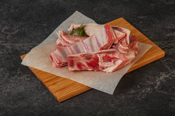 Raw lamb ribs served rosemary for cooking