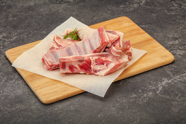 Raw lamb ribs served rosemary for cooking