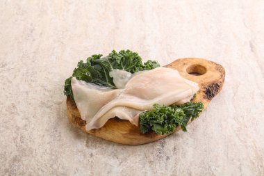 Ahşap tahtada pişirmek için çiğ mürekkep balığı