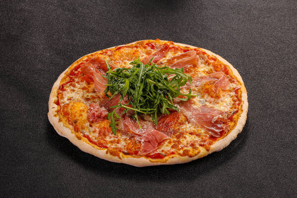 Pizza with parma, cheese and rucola