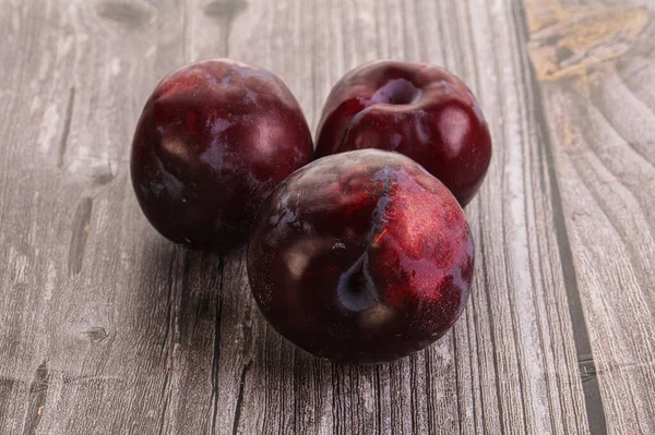 Ripe and sweet purple plum heap over background