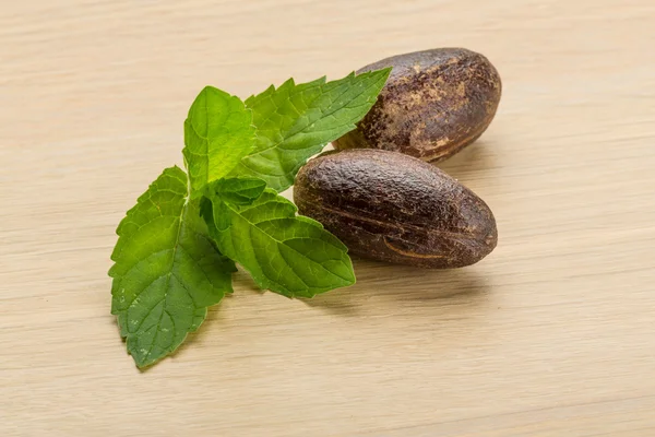 Nutmeg with mint leaves — Stock Photo, Image