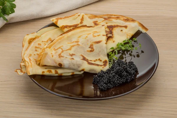 Pancakes with black caviar — Stock Photo, Image