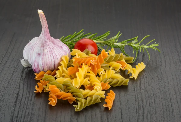 Raw fusilli with rosemary — Stock Photo, Image