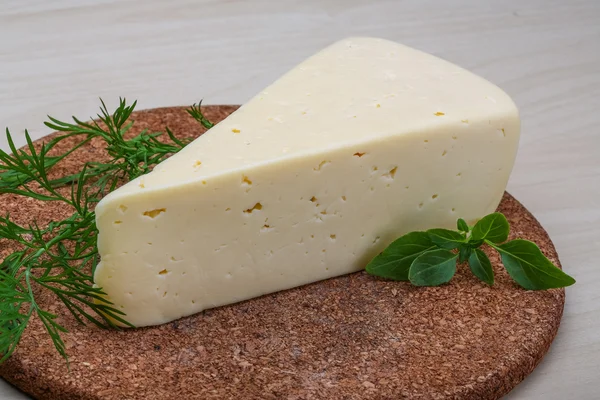 Yellow cheese with rosemary — Stock Photo, Image