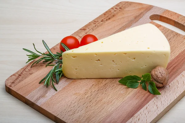 Yellow cheese with rosemary — Stock Photo, Image