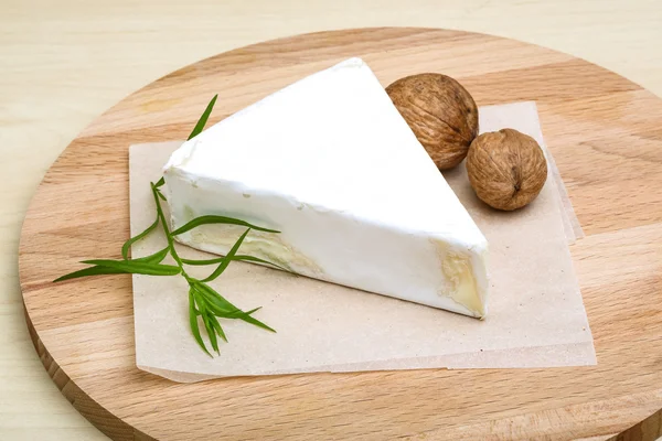 Brie cheese with walnuts and tarragon — Stock Photo, Image