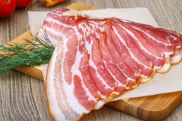 Cold sliced bacon with dill — Stock Photo, Image