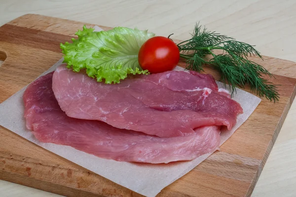 Raw pork schnitzel with dill — Stock Photo, Image