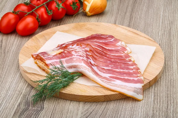 Cold sliced bacon with dill — Stock Photo, Image