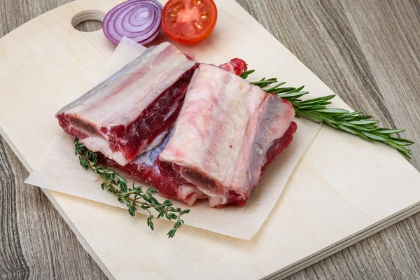 Raw beef ribs  with rosemary — Stock Photo, Image