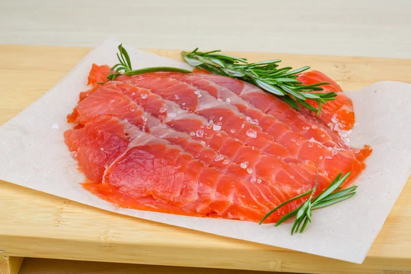 Sliced salmon with rosemary — Stock Photo, Image