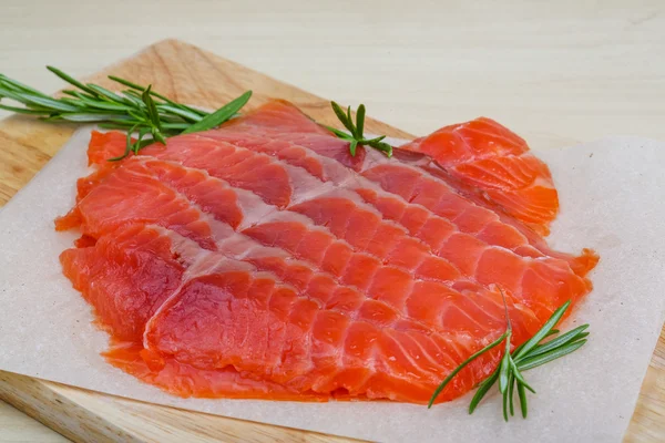 Sliced salmon with rosemary — Stock Photo, Image