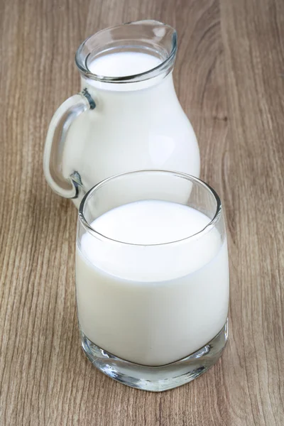 Milk in glass and jug — Stock Photo, Image